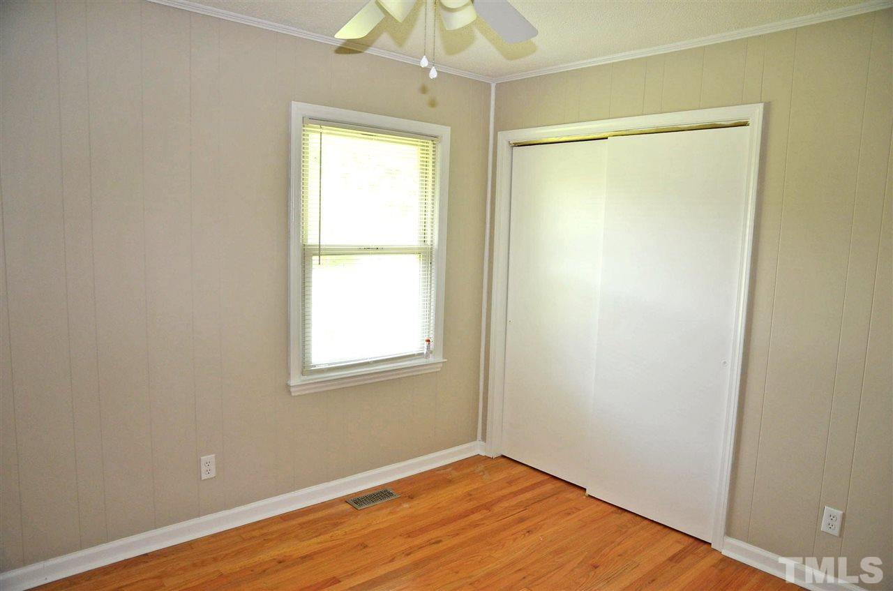 4228 Lassiter Road Wake Forest, NC 27587 - Photo 18 of 20 an empty room with a window and wooden floor
