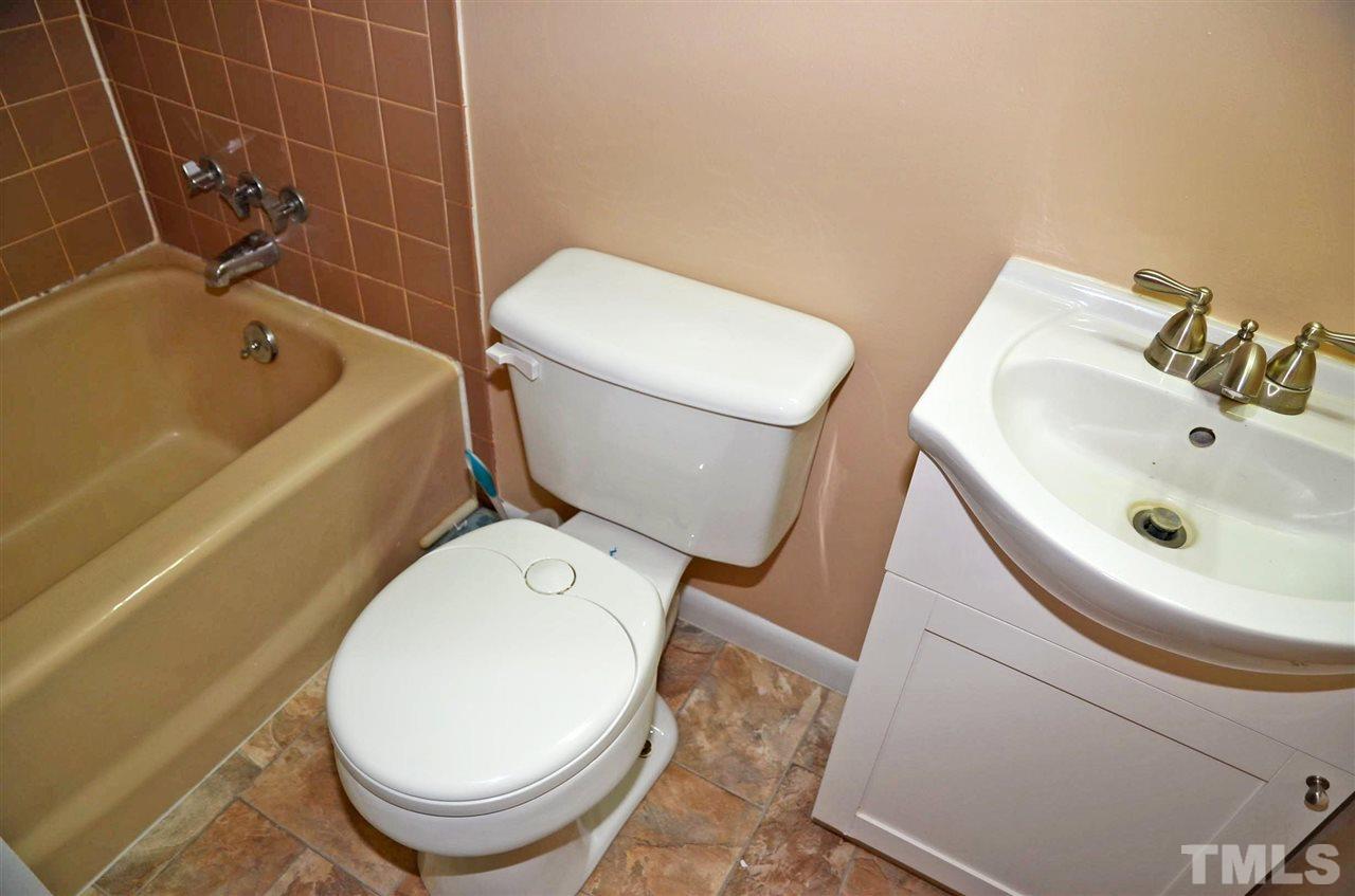 4228 Lassiter Road Wake Forest, NC 27587 - Photo 19 of 20 a white toilet sitting next to a bath tub