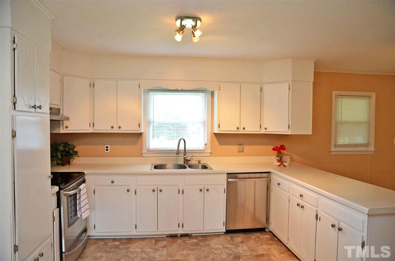 4228 Lassiter Road Wake Forest, NC 27587 - Photo 4 of 20 a kitchen with white cabinets appliances and a window