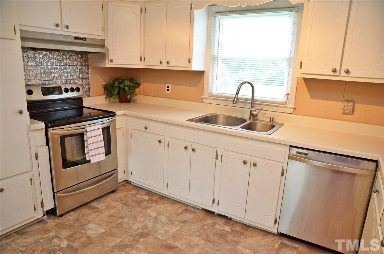 4228 Lassiter Road Wake Forest, NC 27587 - Photo 6 of 20 a kitchen with granite countertop a sink a stove and cabinets