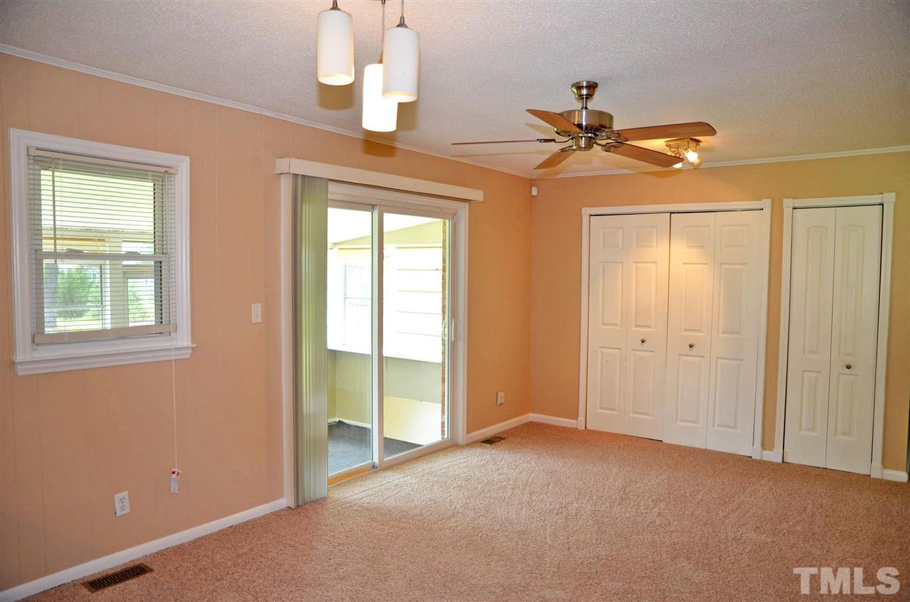4228 Lassiter Road Wake Forest, NC 27587 - Photo 8 of 20 a view of a room with a ceiling fan and window
