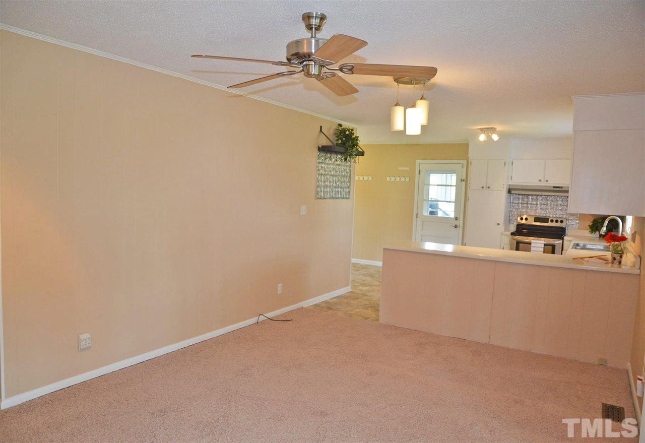 4228 Lassiter Road Wake Forest, NC 27587 - Photo 9 of 20 a view of a living room with a ceiling fan