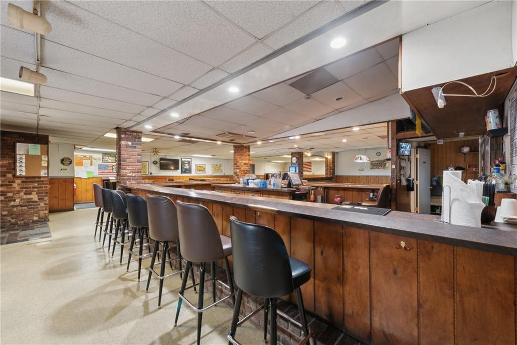 155 Smolleck Street Whitney, PA 15693 - Photo 11 of 39 a dining hall with stainless steel appliances granite countertop a dining table and chairs with wooden floor