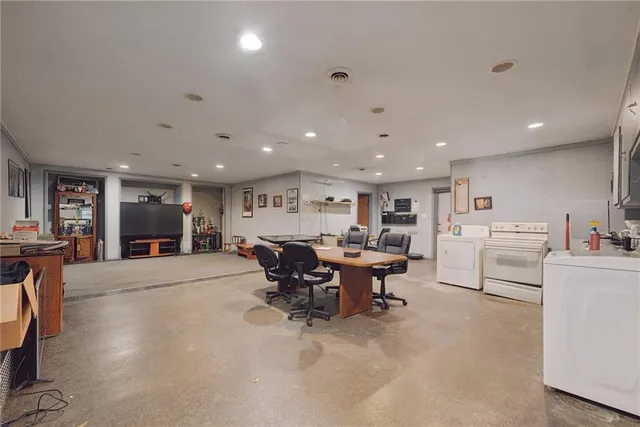 a view of a kitchen with workspace and living room