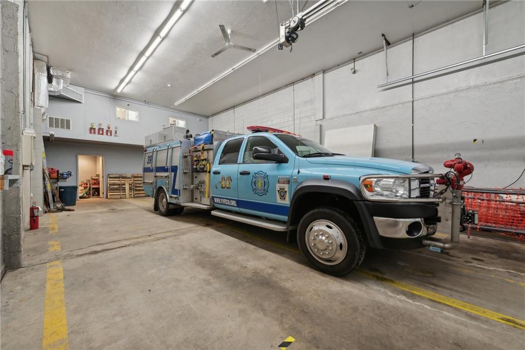 155 Smolleck Street Whitney, PA 15693 - Photo 30 of 39 a car and bike parked in a garage
