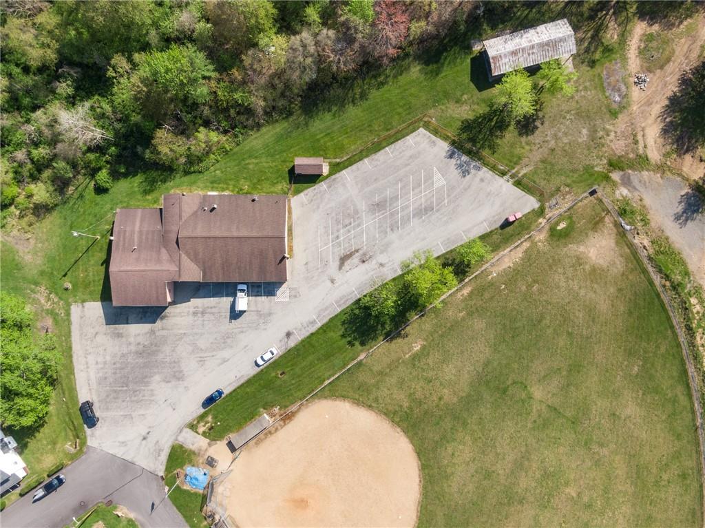 155 Smolleck Street Whitney, PA 15693 - Photo 35 of 39 an aerial view of a house with a yard and lake view