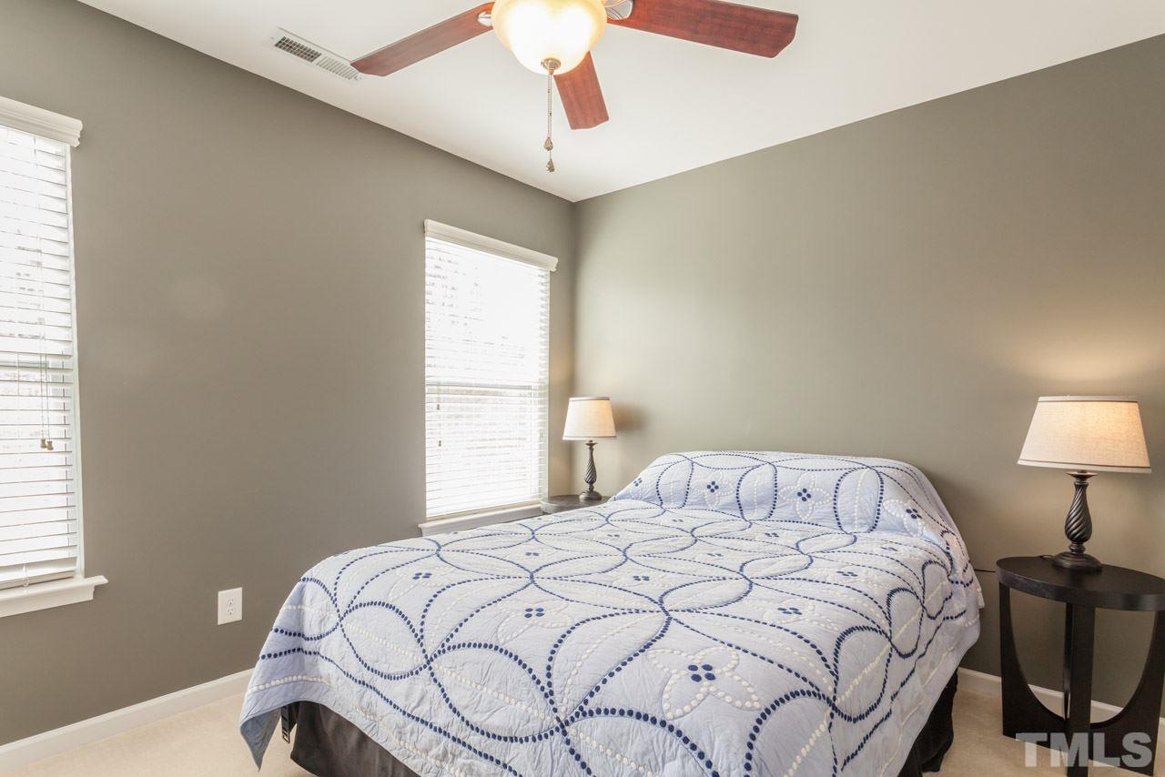 2427 Memory Ridge Drive Raleigh, NC 27606 - Photo 12 of 22 a bedroom with a bed and a table in it