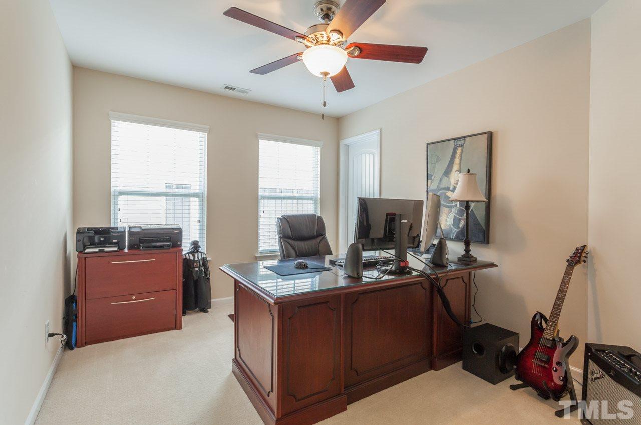 2427 Memory Ridge Drive Raleigh, NC 27606 - Photo 13 of 22 a room with kitchen island a workspace and a window