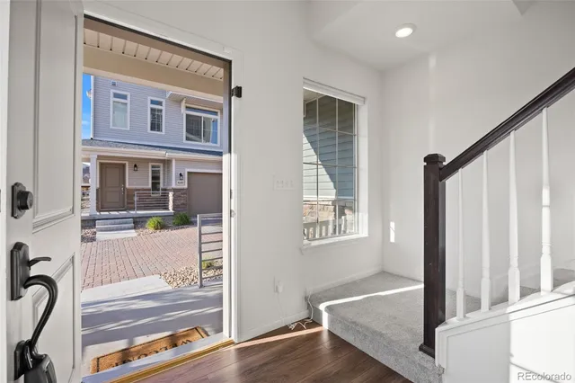 a view of a livingroom with furniture and hardwood floor