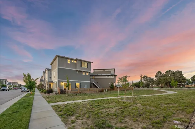 an aerial view of a house with a garden and lake view