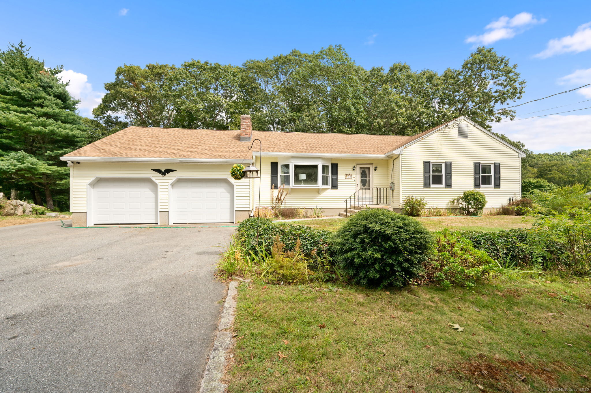 a front view of a house with a garden
