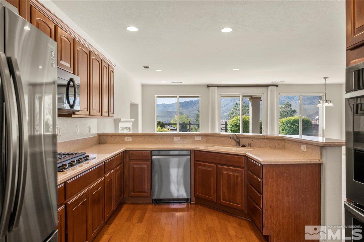 1125 Cliff Park Way Reno, NV 89523 - Photo 12 of 40 a kitchen with stainless steel appliances granite countertop a sink stove and refrigerator