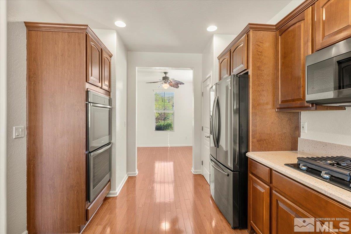 1125 Cliff Park Way Reno, NV 89523 - Photo 14 of 40 a kitchen with stainless steel appliances granite countertop a refrigerator and a stove top oven