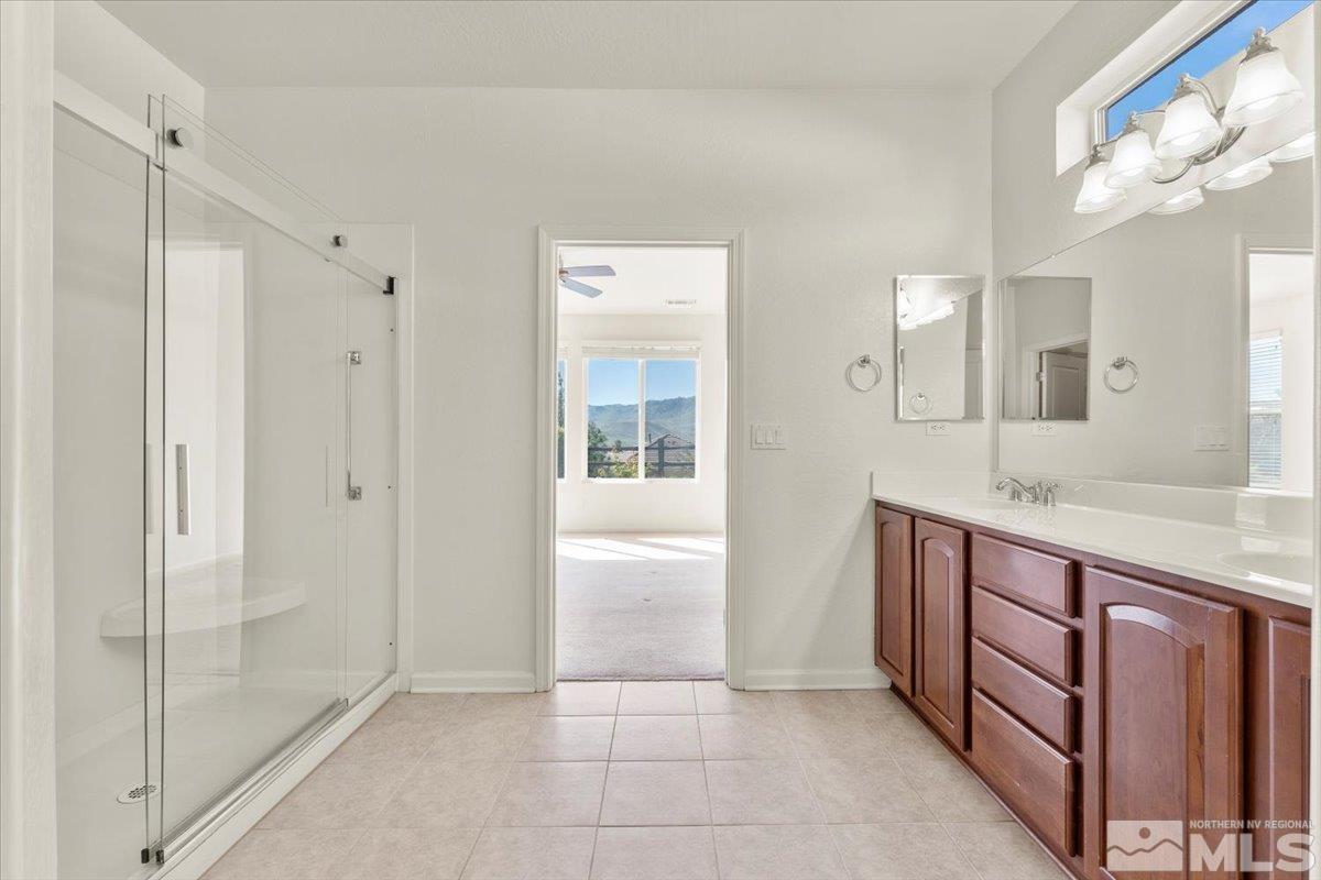 1125 Cliff Park Way Reno, NV 89523 - Photo 20 of 40 a bathroom with a granite countertop sink a mirror and a shower