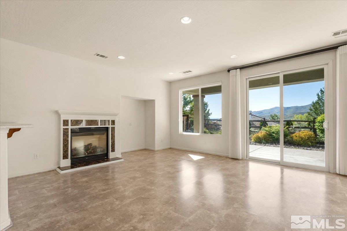 1125 Cliff Park Way Reno, NV 89523 - Photo 5 of 40 an empty room with floor to ceiling window and fireplace
