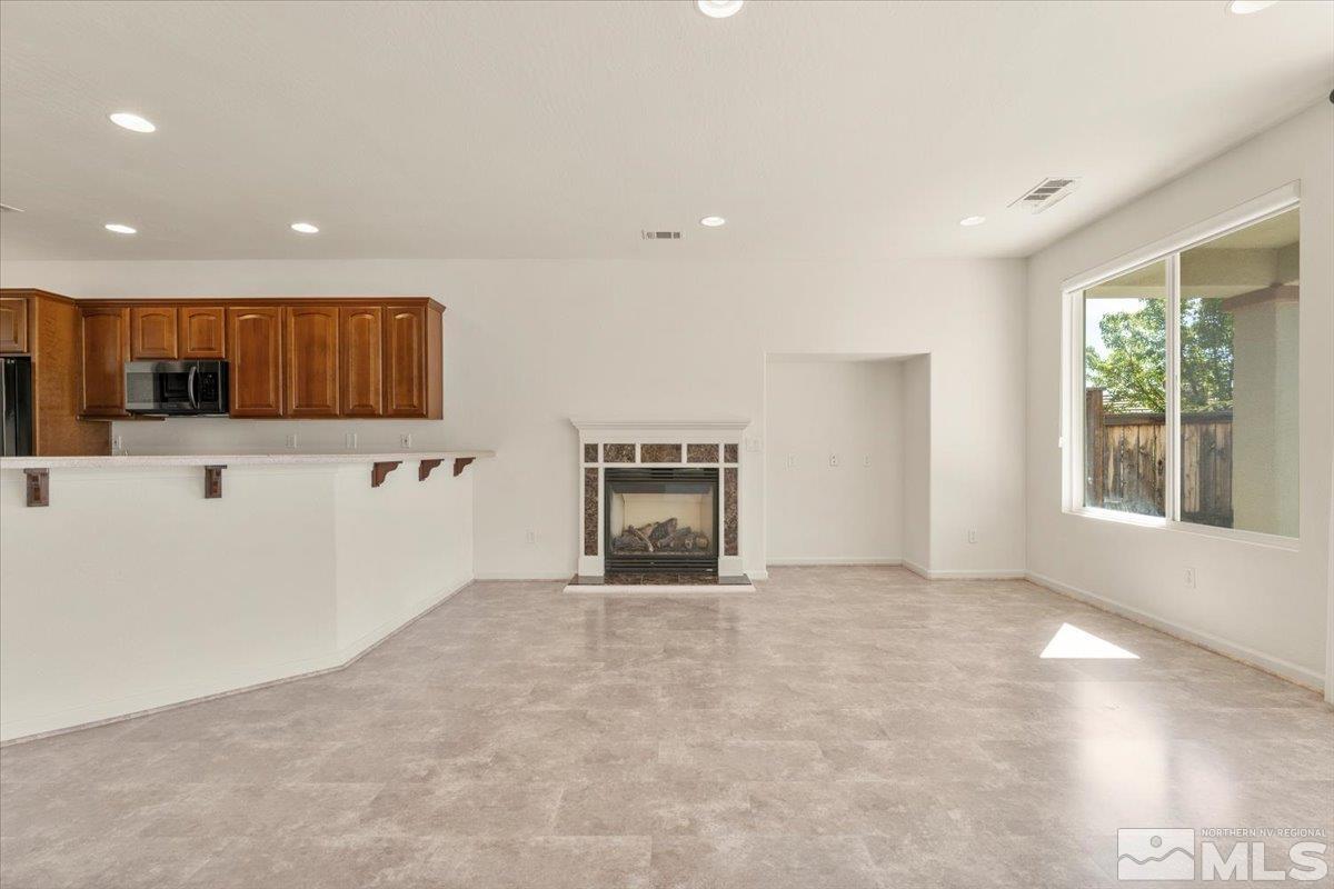 1125 Cliff Park Way Reno, NV 89523 - Photo 6 of 40 a view of an empty room with a fireplace and a window