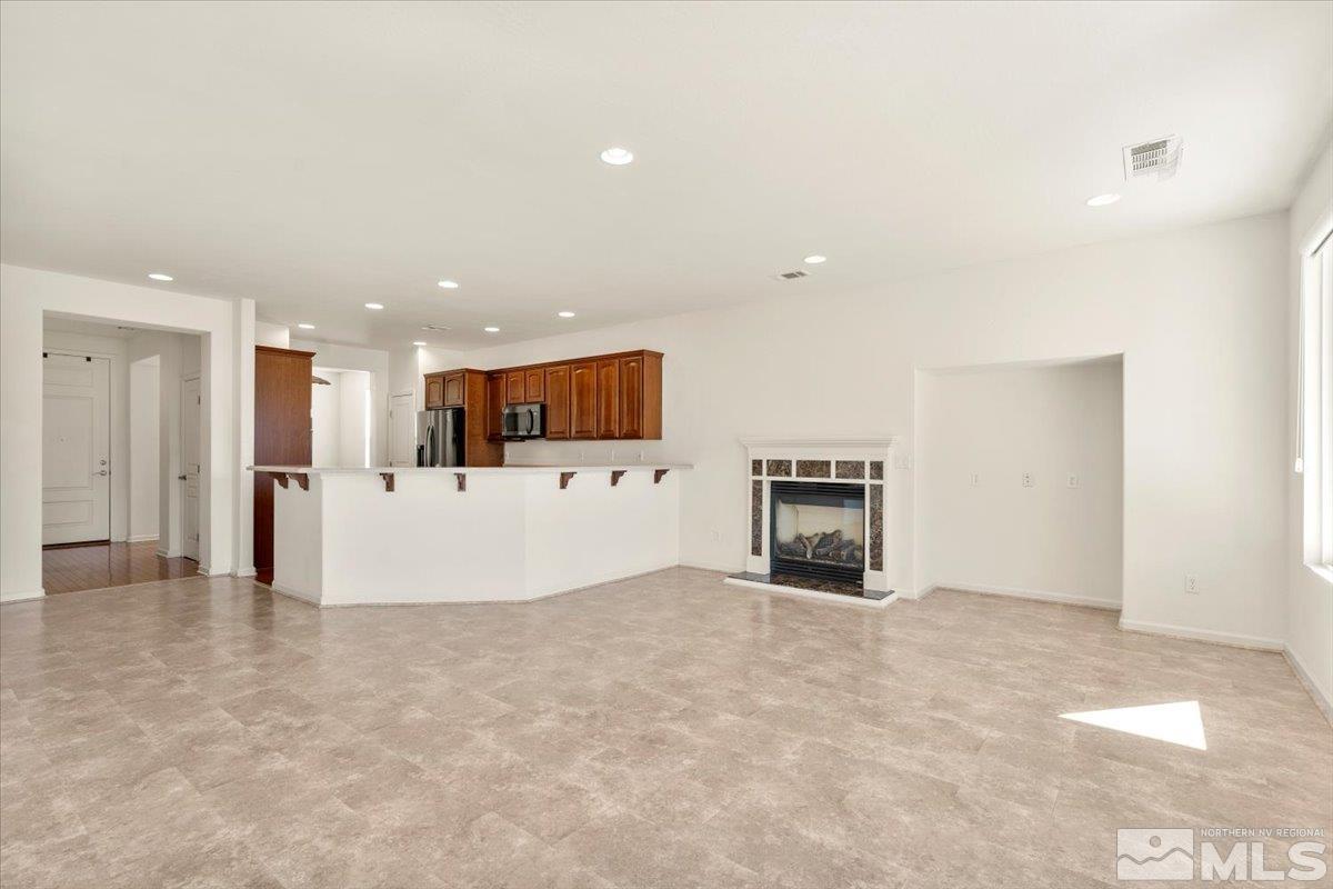 1125 Cliff Park Way Reno, NV 89523 - Photo 7 of 40 a view of kitchen with refrigerator and a fireplace