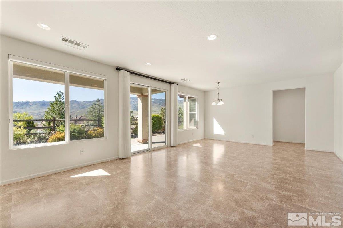 1125 Cliff Park Way Reno, NV 89523 - Photo 8 of 40 a view of an empty room with a window and wooden floor
