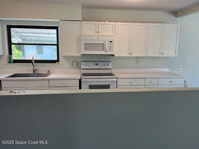 589 Michael Street Sebastian, FL 32958 - Photo 14 of 36 a kitchen with granite countertop white cabinets and sink