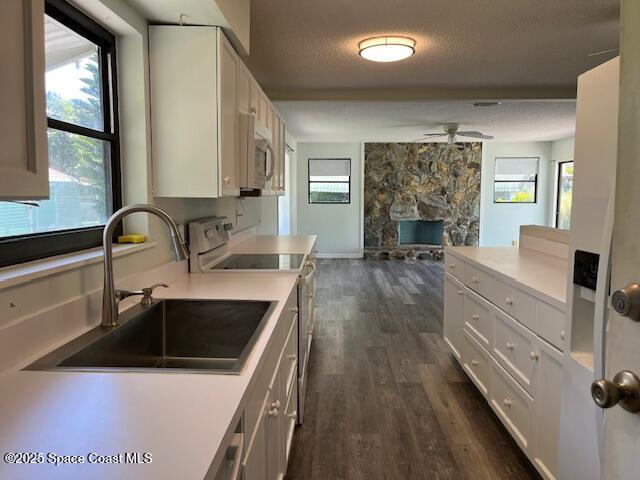 589 Michael Street Sebastian, FL 32958 - Photo 16 of 36 a kitchen with a sink stove and cabinets