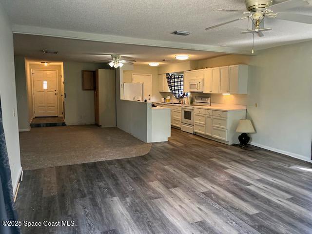 589 Michael Street Sebastian, FL 32958 - Photo 21 of 36 a view of a kitchen and a refrigerator in a room