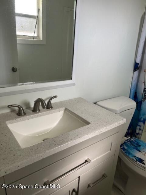 589 Michael Street Sebastian, FL 32958 - Photo 27 of 36 a bathroom with a sink and a toilet