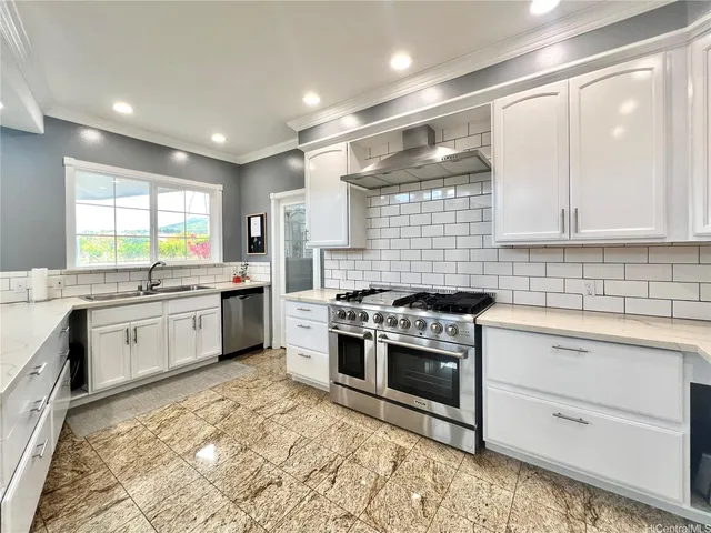 a kitchen with stainless steel appliances and white cabinets