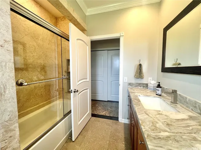 a bathroom with a granite countertop sink mirror and a bathtub