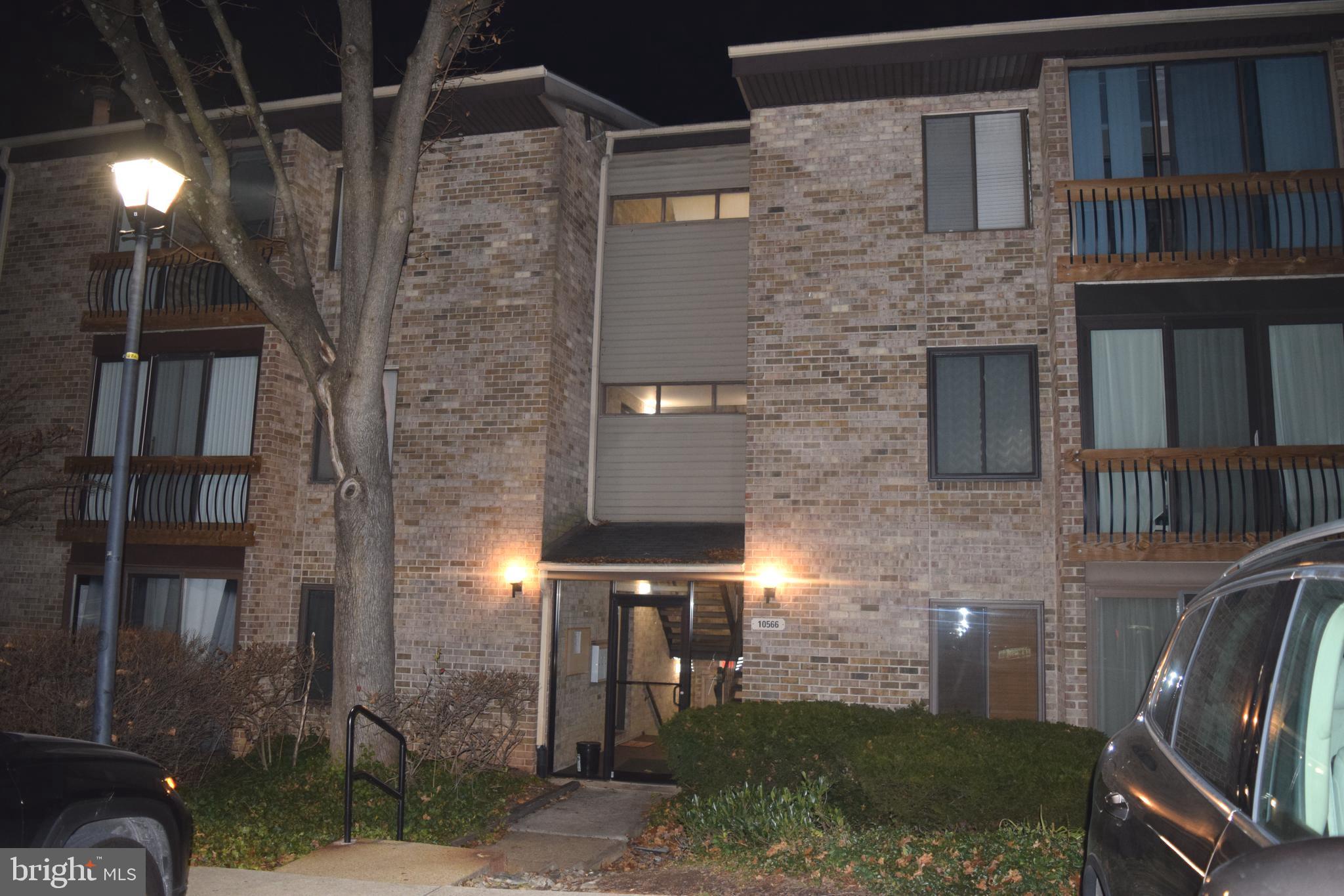 10566 Twin Rivers Road, Unit F1 Columbia, MD 21044 - Photo 44 of 44 a view of a brick house with a yard