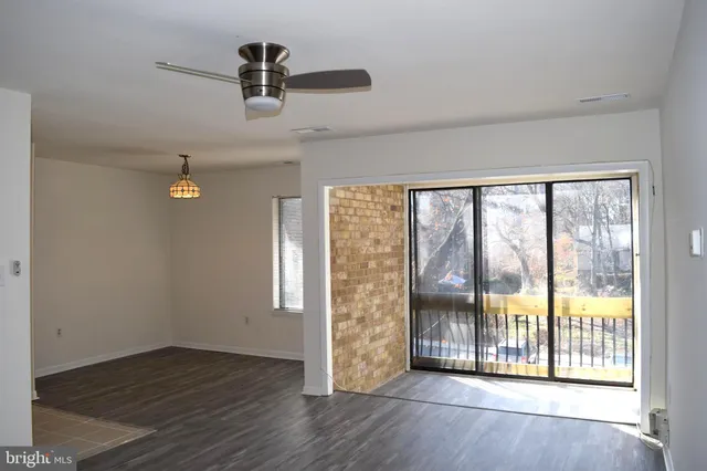 an empty room with wooden floor and a fireplace