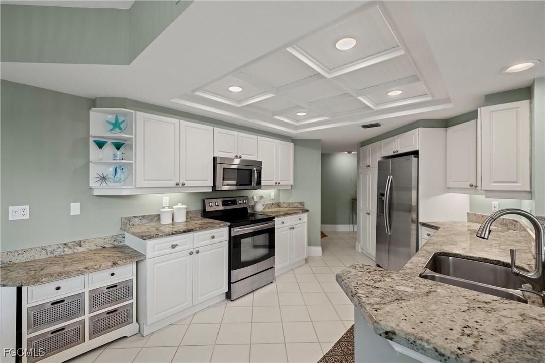 2619 Wulfert Road, Unit 1 Sanibel, FL 33957 - Photo 12 of 35 a kitchen with stainless steel appliances granite countertop a sink stove refrigerator and cabinets