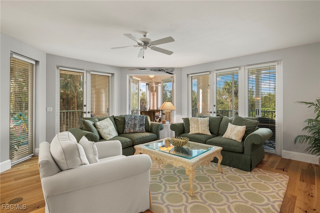 2619 Wulfert Road, Unit 1 Sanibel, FL 33957 - Photo 5 of 35 a living room with furniture ceiling fan and a large window