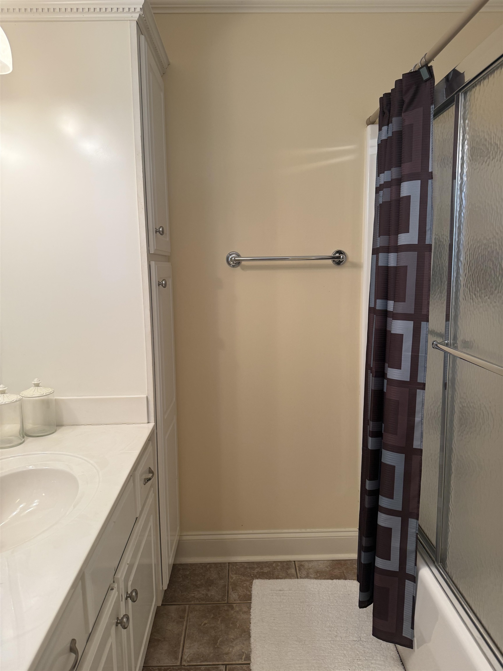 14 Patsy Path Iuka, MS 38852 - Photo 19 of 33 Full bath featuring shower / bath combination with glass door, tile patterned flooring, vanity, and baseboards