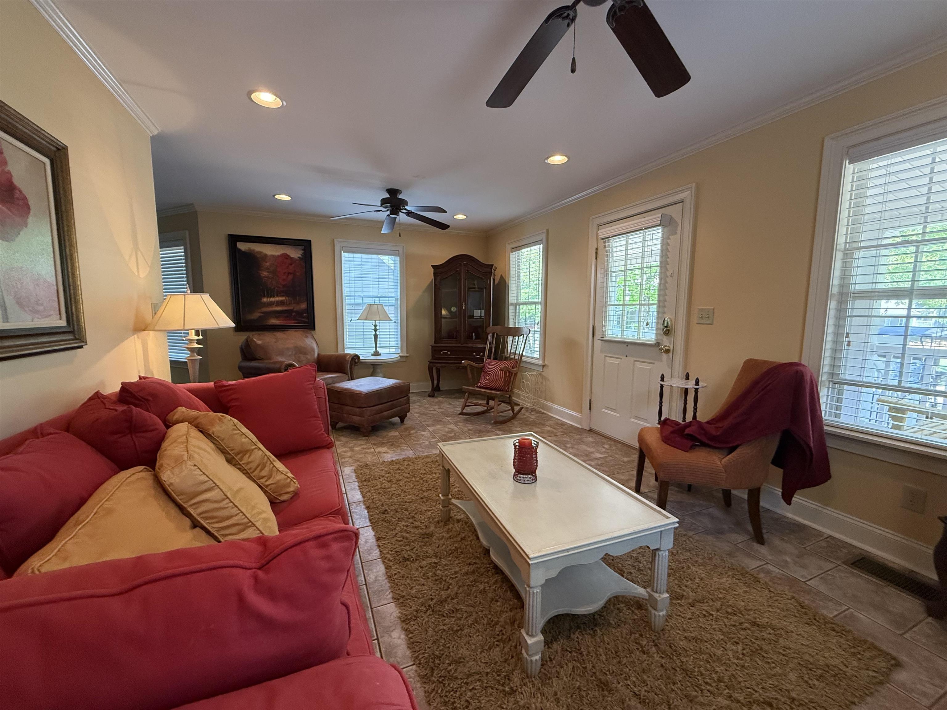 Living area with ornamental molding, recessed lighting, a ceiling fan, and baseboards