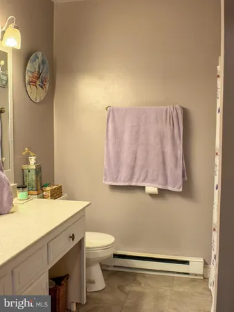 a bathroom with a sink mirror vanity and toilet