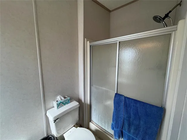 a bathroom with a toilet and a mirror