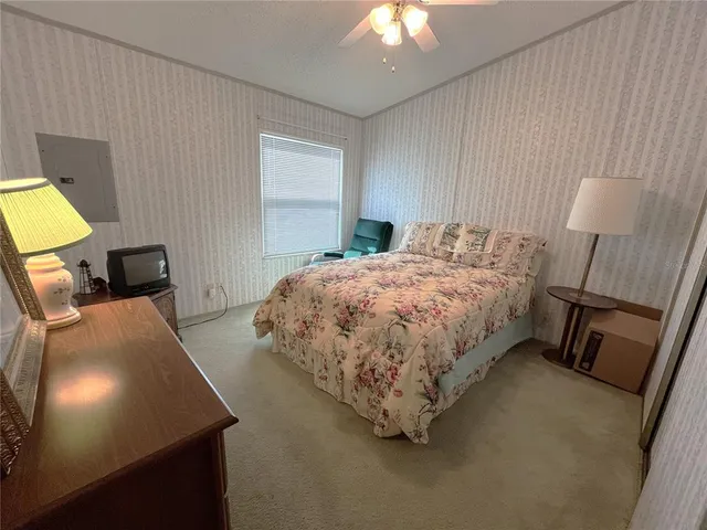 a bedroom with a bed and a tv