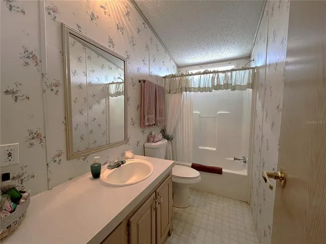 a bathroom with a sink toilet tub and shower