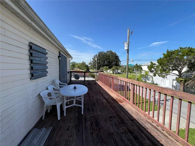 a balcony with table and chairs