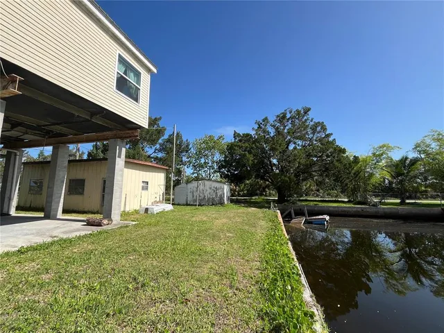 a view of a backyard with plants and a patio