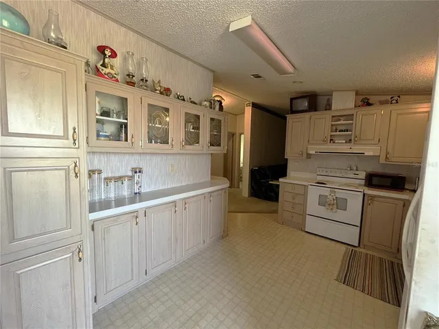 a kitchen with stainless steel appliances white cabinets and a refrigerator