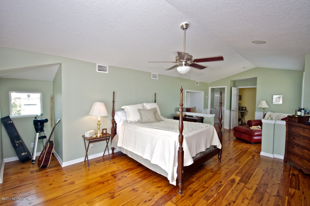 1960 Beach Avenue Atlantic Beach, FL 32233 - Photo 12 of 28 a bedroom with bed and a chandelier