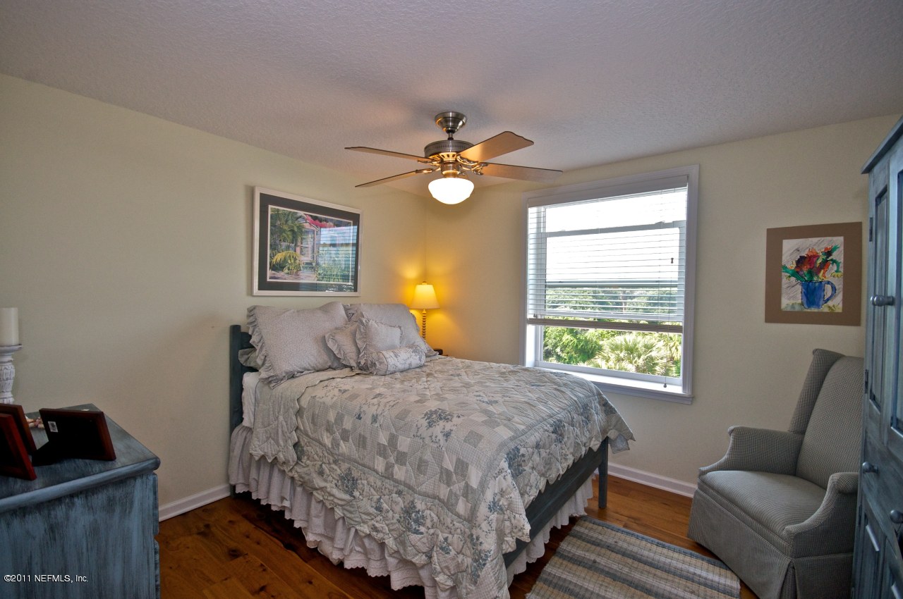 1960 Beach Avenue Atlantic Beach, FL 32233 - Photo 18 of 28 a bedroom with a bed and wooden floor
