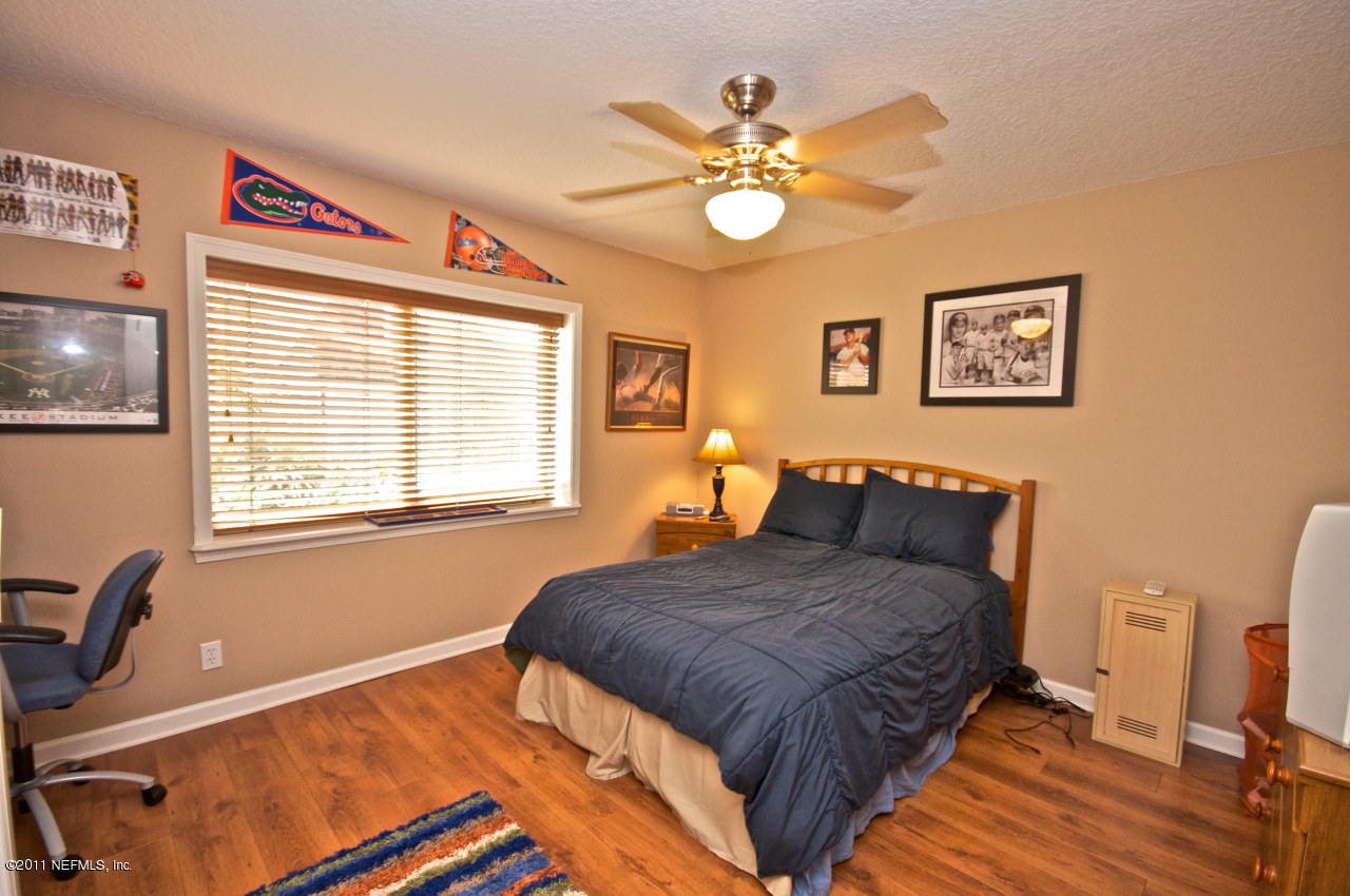 1960 Beach Avenue Atlantic Beach, FL 32233 - Photo 19 of 28 a bedroom with a bed and a chandelier
