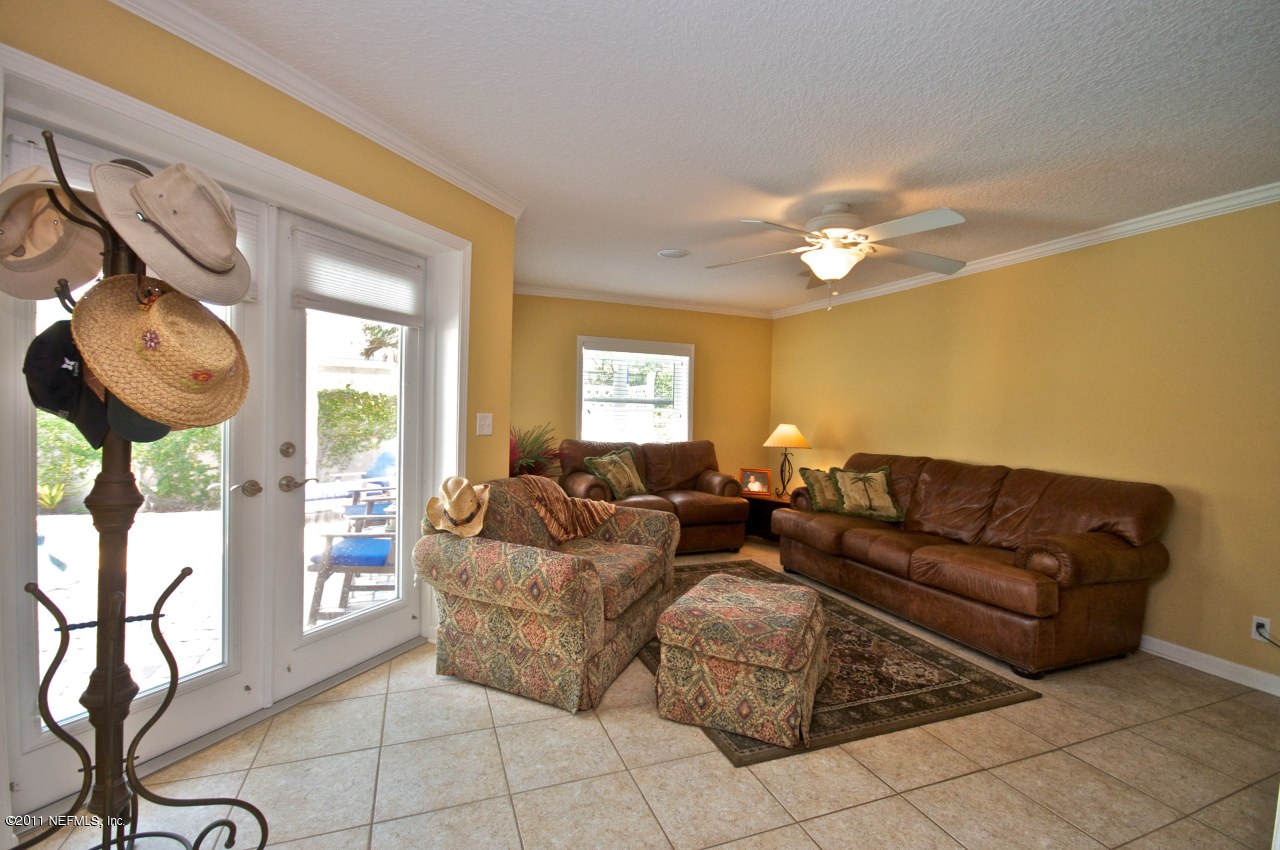 1960 Beach Avenue Atlantic Beach, FL 32233 - Photo 22 of 28 a living room with furniture a chandelier and a window