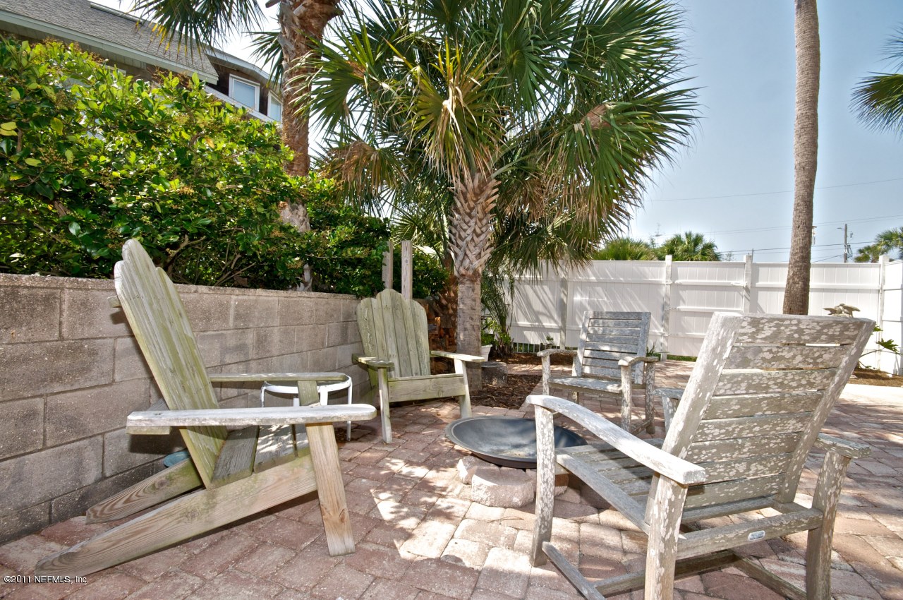 1960 Beach Avenue Atlantic Beach, FL 32233 - Photo 26 of 28 a view of a patio with table and chairs potted plants and palm tree