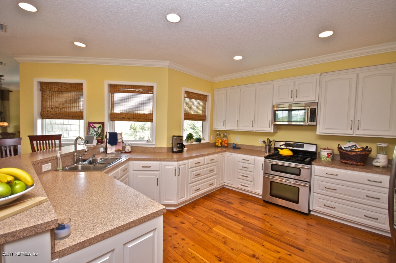 1960 Beach Avenue Atlantic Beach, FL 32233 - Photo 8 of 28 a kitchen with wooden floors and appliances