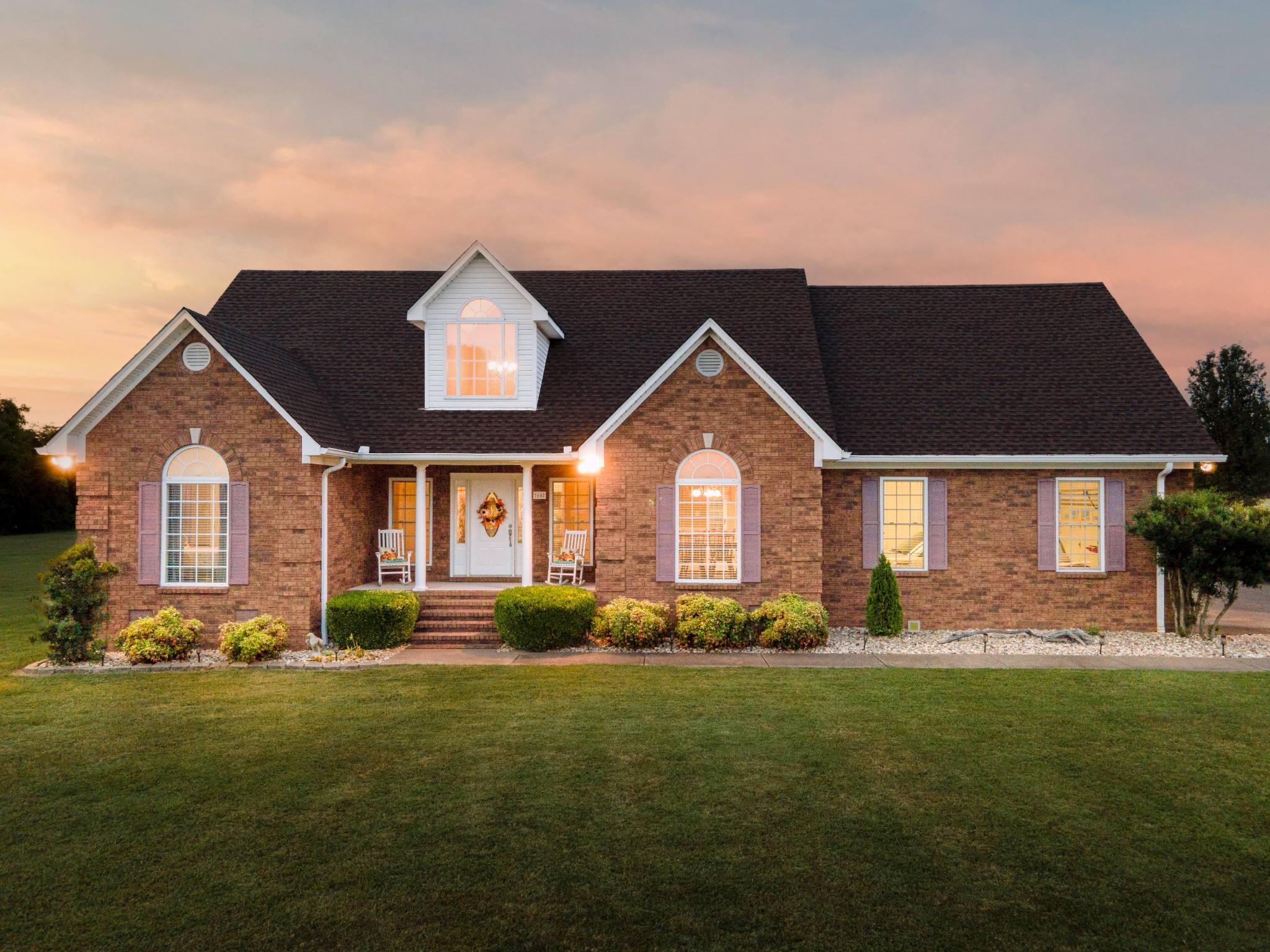 a front view of a house with garden