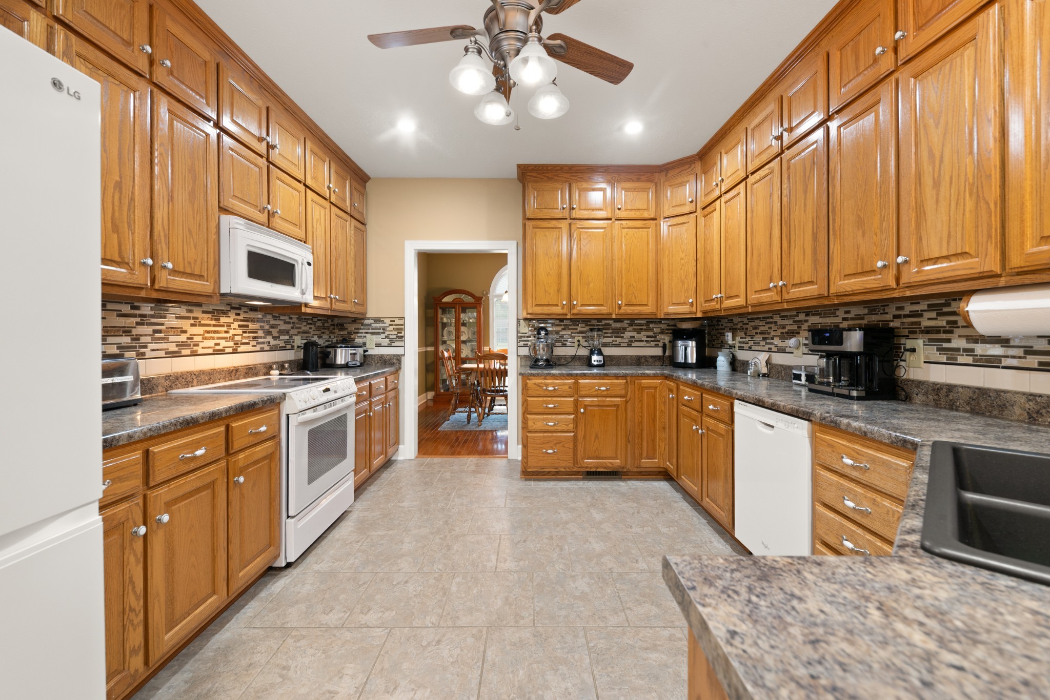 1642 Caughran Road Lewisburg, TN 37091 - Photo 18 of 92 a kitchen with stainless steel appliances granite countertop a stove a sink dishwasher a refrigerator and cabinets with wooden floor