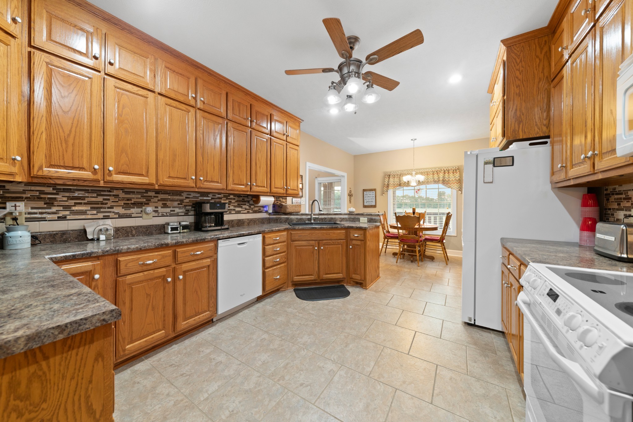 1642 Caughran Road Lewisburg, TN 37091 - Photo 21 of 92 a kitchen with a stove a sink and a refrigerator